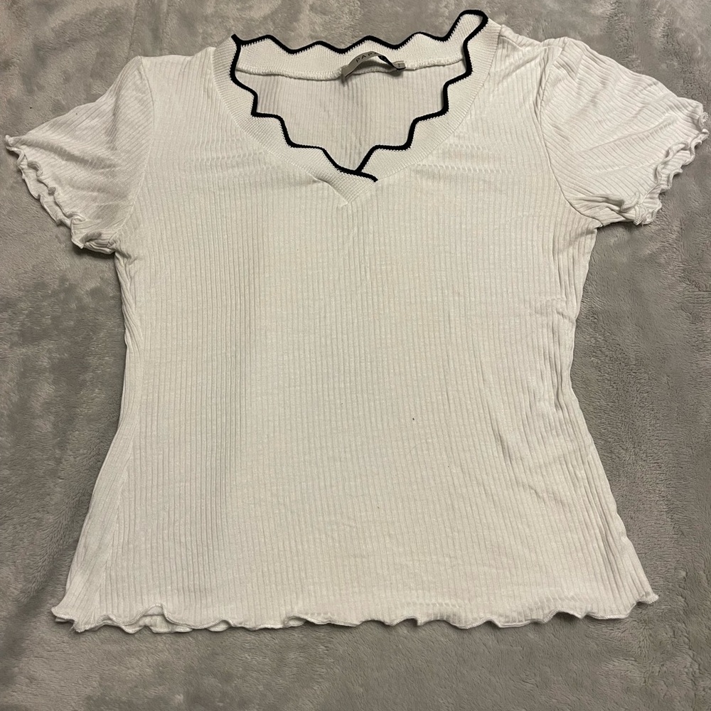 White shirt with black trim, V-neck